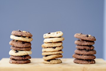 stack of Delicious Chocolate Chip Cookies, three rows of Tasty Homemade cookies on wooden table with copy space.