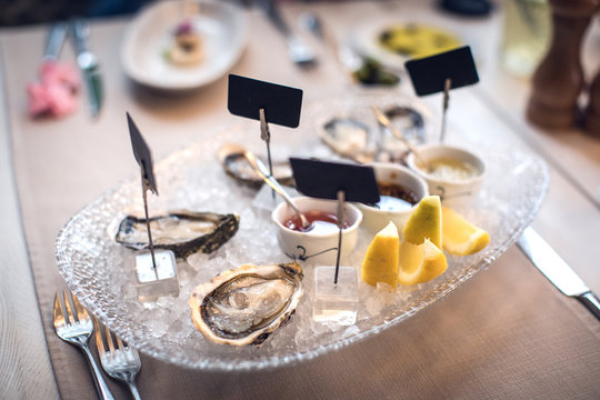 Tasty oysters on ice with lemon