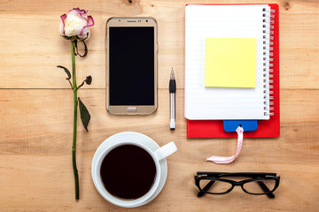 Mobile phone, glasses, cup of tea, flowers, stationery