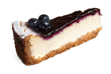 Single slice of blueberry cheesecake with fresh blueberries isolated on white.