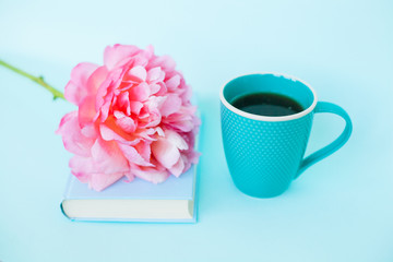 Peony flower and book on blue background