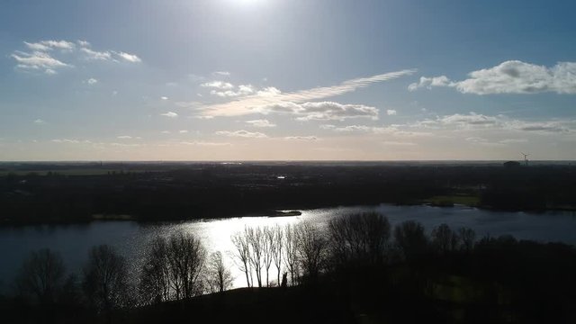 Netherlands – Amsterdam South East – Gaasperpark – Drone view over the water towards Abcoude with backlight