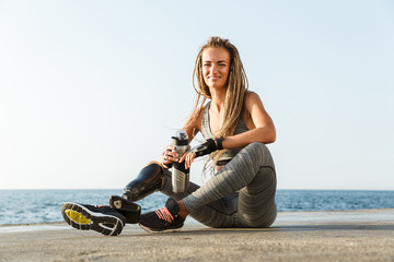 Smiling disabled athlete woman with prosthetic leg