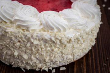 Strawberry Cake dessert with candies on wooden background