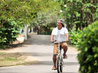 Senior Couple cyling in Park.Health care concept.