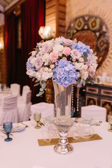 Magnificent, volume bouquets of flowers in high glass vases