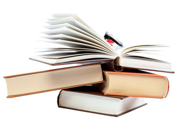 Open book and glasses on a stack of books