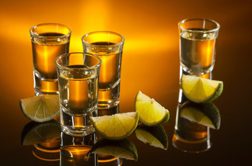 Tequila and lime slices .