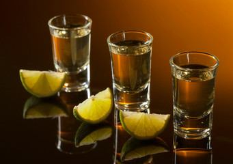 Tequila and lime slices .