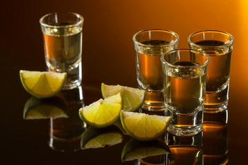 Tequila and lime slices .