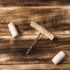 Fototapeta na wymiar wine corks and corkscrew on a wooden background, still life for restaurants