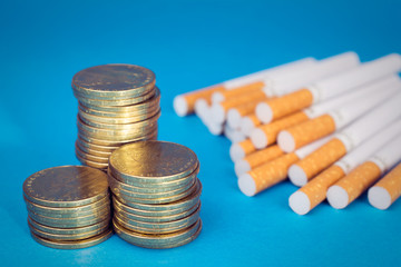 Cigarette price concept. Cigarettes  money gold coins