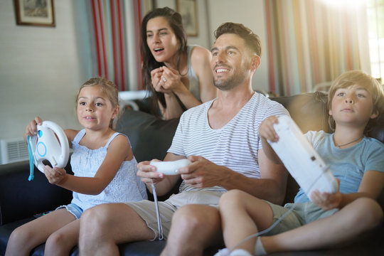 Family having fun at home playing video game