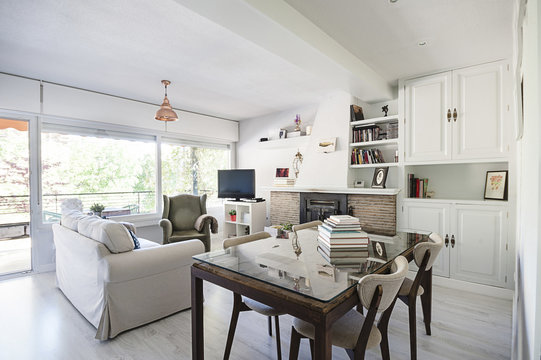 Sofa and table in front of fireplace in living room of a modern apartment