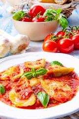 Delicious pasta - ravioli in tomato sauce with basil