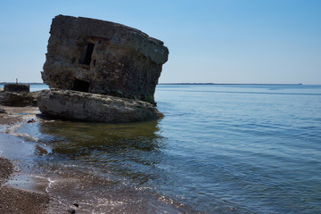 Naklejka premium Bunker ruins near the Baltic Sea beach, part of the old fortress in the former Soviet Union base 