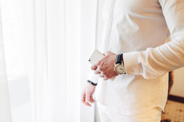Young Man in White Suit in Hotel Room