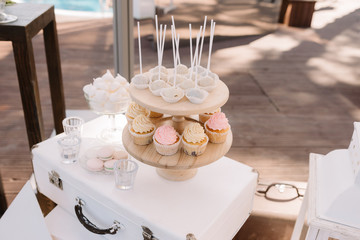 Sweet products at a wedding. Tasty cookies and cakes on glasswares