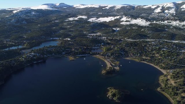 Aerial drone scene of Villa Pehuenia, Moquehue, Neuquen, Patagonia Argentina. Camera moving forwards from Alumine lake.  Batea Mahuida volcano with snow 