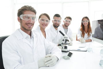 Male scientist and the team in the lab.