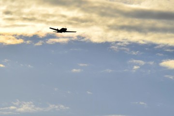 Fototapeta na wymiar single engine low wing propeller airplane silhouette flying in the evening sky 