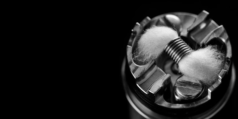 black and white, monochrome shot of single micro coil with japanese organic cotton wick in high end rebuildable dripping atomizer for flavour chaser, vaping device, vape gear, vaporizer equipment