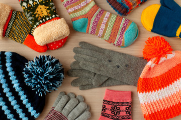 Autumn and winter clothes. Scattered warm clothes like hats, mittens, gloves and socks. Warm...