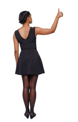 Back view of a black woman showing thumb up.
