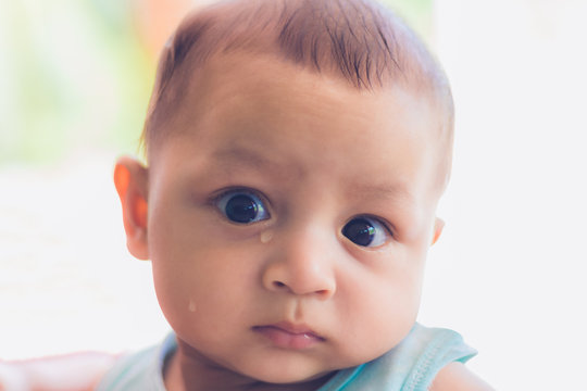Portrait of cute newborn baby crying, Sad asian child