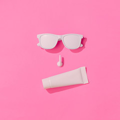 Creative hipster layout with copy space and various summer objects on pastel pink background....