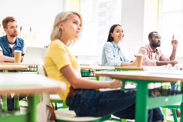 Fototapeta premium focused young students sitting in classroom during lesson