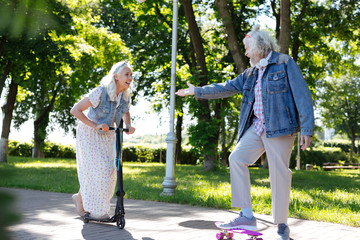 Come here. Happy positive man giving his hand while helping his wife