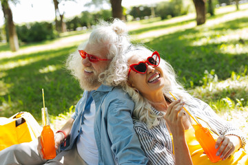 So thirsty. Joyful happy couple smiling while having drinks together