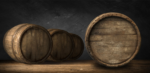 Beer barrel with beer glass on table on wooden background