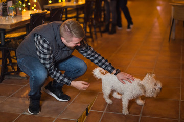 Young man plays with dog