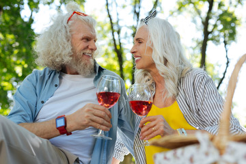 Our holiday. Happy aged couple looking at each other while celebrating anniversary