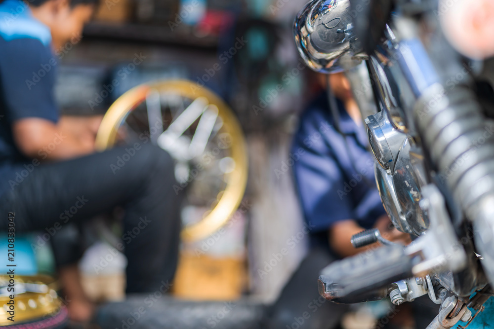 Wall mural automobile mechanic repairing motorcycle in bike repair shop