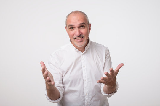 Inspired mature italian man expressing strong emotion while explaining something.