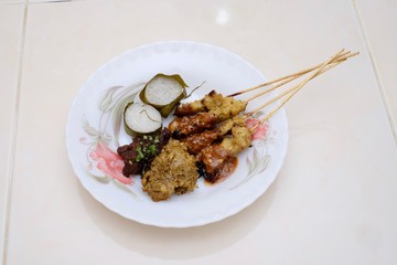 Chicken satay, Lemang and Rendang  on the white plate. Traditional Malay food, Eid Fitr dish. Malaysian cuisine.