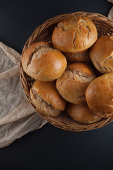 fresh, crunchy spelt rolls, sourdough with napkin on a dark slate plate kitchen table