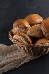 fresh, crunchy spelt rolls, sourdough with napkin on a dark slate plate kitchen table