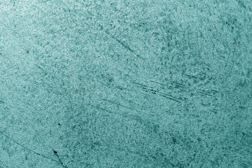 Grungy cement wall in cyan tone.