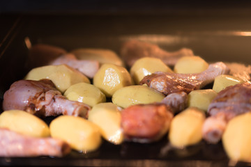 Raw or fresh chicken in the oven with potatoes, lunch time