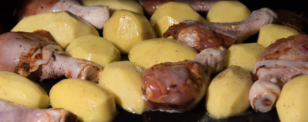 Raw or fresh chicken in the oven with potatoes, lunch time