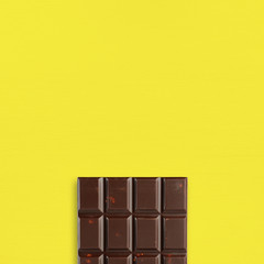 Chocolate on yellow table top view