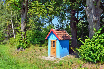 Fototapeta na wymiar Blue small chapel in nature