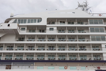 Portside of a cruise liner with dozens of balconies