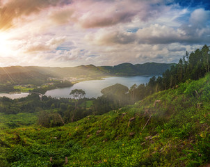 Obraz premium Beautiful sunset volcanic lake among mountains with green lush and trees in Ciete Cidades valley