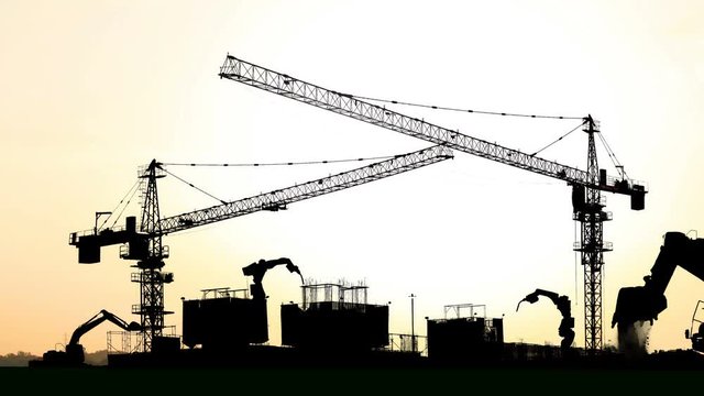 4k,time lapse of tower cranes at construction site with sun 
