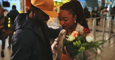 Young emotional couple embracing at airport after flight arrival - Powered by Adobe
